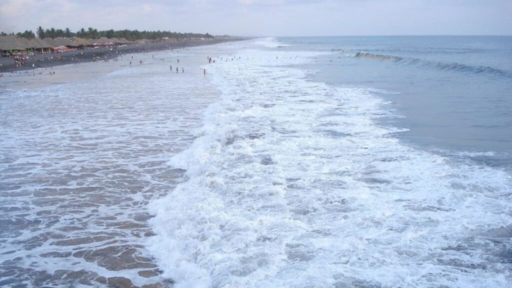 Champerico Beach, near the Mexican border, is a popular surfing spot on Guatemala's Pacific coast, attracting locals and travelers looking to catch some waves.